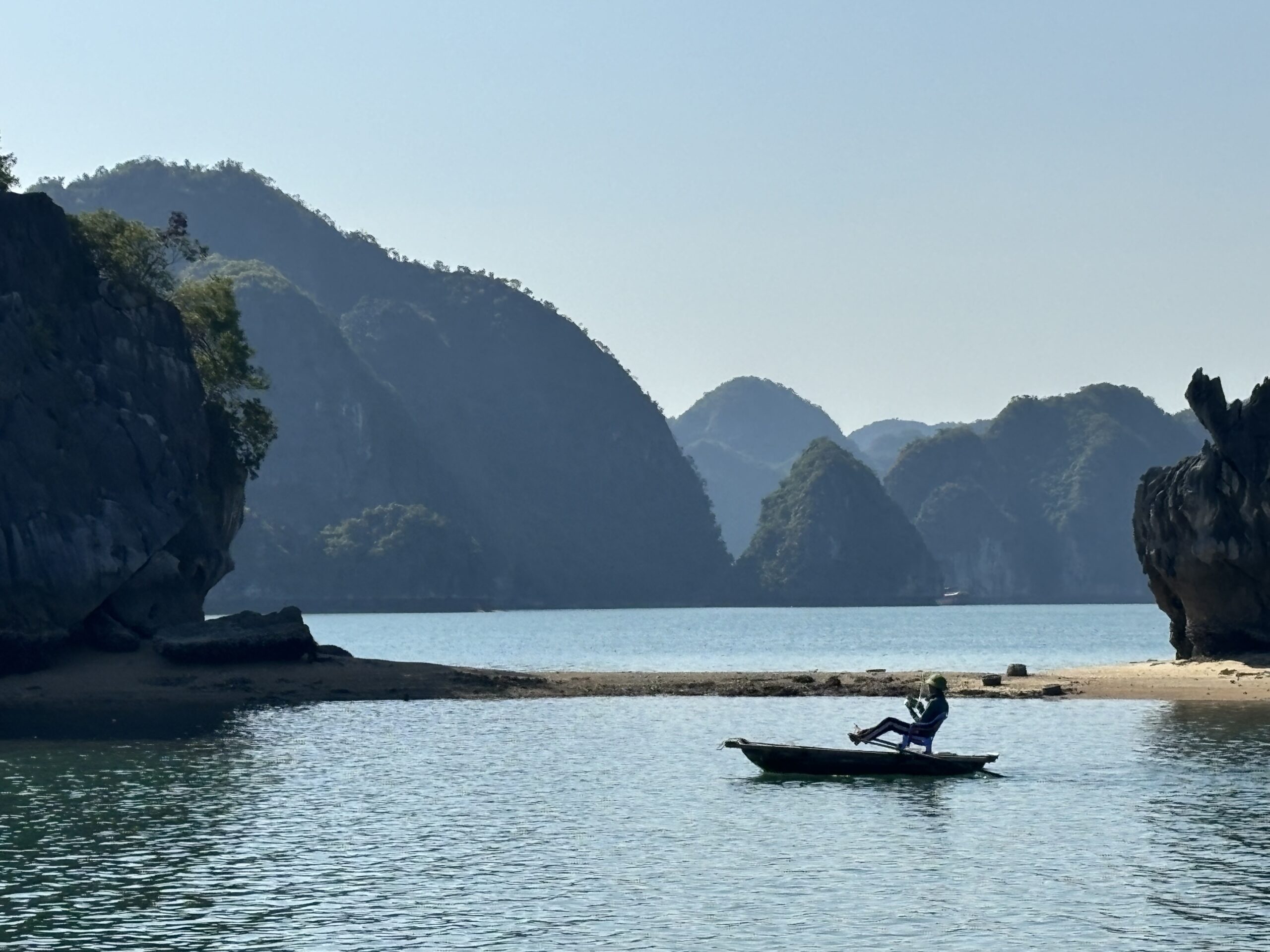 Man on pedal fishing boat in the sea off Vietnam